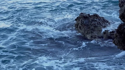 Ocean wave beats of the big rocks standing in the ocean. Close up of big Stock Footage 186776033