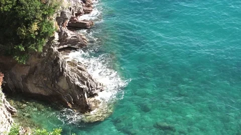 Ocean wave beats of the big rocks standing in the ocean. Close up of big Stock Footage 195556995
