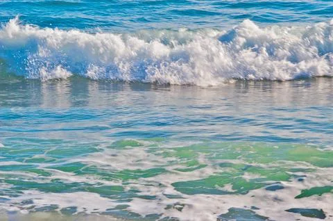 Ocean wave breaking creating white foam Stock Photos