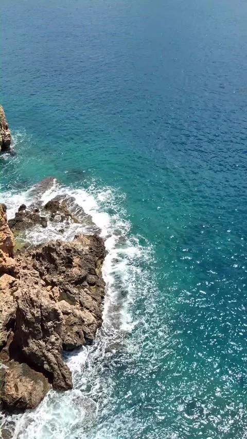 Ocean wave crash on sea cliff along rocky coast Stock Footage 340537488