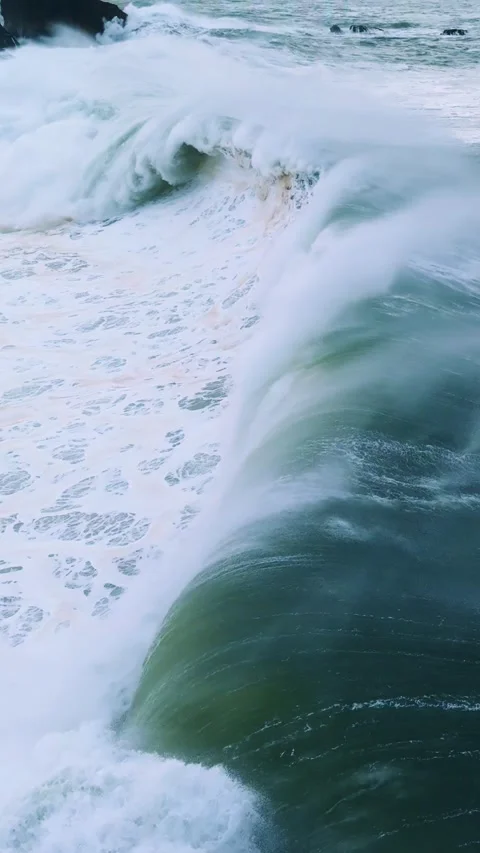 Ocean Wave Crashing with Force In Slow Motion. The emerald-green water contrasts Stock Footage 296696584