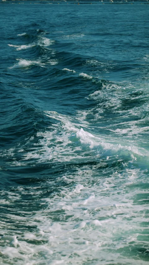 Ocean wave cresting, showing clear blue water and swirling white foam, creating Stock Footage 339821887