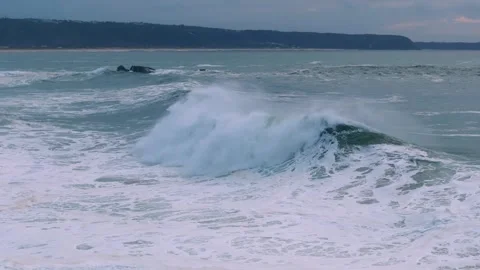 Ocean Wave Cresting Under a Cloudy Sunset Sky Video stock 297468552