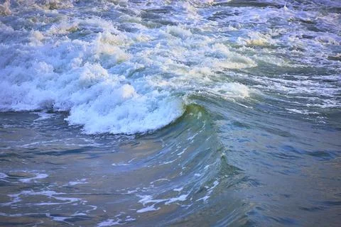 Ocean Wave Curl and Surf Close Up with Vibrant Blue Water Stock Photos