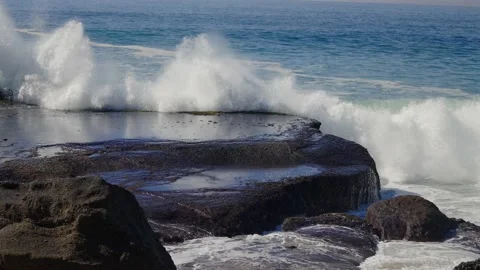 Ocean wave exploding onto rocks  and washing over. Slowed to quarter speed Stock Footage 165430622