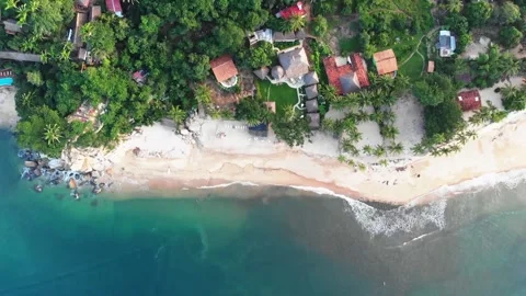 Ocean wave flowing towards restaurant on the coastal beach Stock Footage 143392524