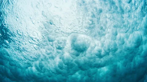 Ocean wave forms underwater clouds. Crystal clear ocean wave rolls and breaks. Stock Footage 167115816