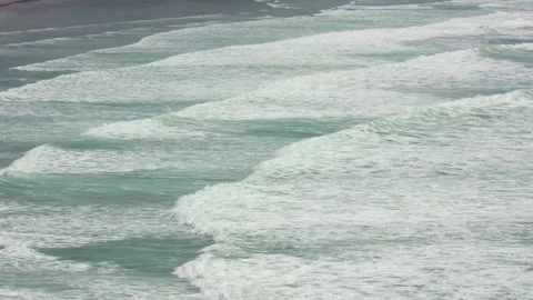 Ocean wave movement with dynamic foam captured close-up from above, showcasing n Stock Footage 309324976