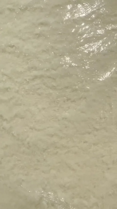 Ocean wave receding from shore topdown abstract sea foam background Stock Footage 331750530