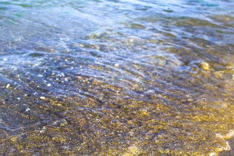 Ocean wave on sandy beach background Stock Photos