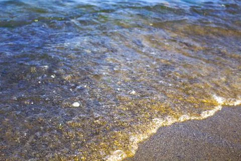 Ocean wave on sandy beach background Stock Photos