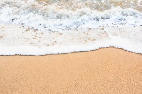 Ocean wave on sandy beach Stock Photos