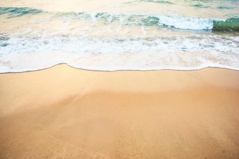 Ocean wave on sandy beach Stock Photos