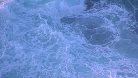 Ocean wave in soft morning light crashing onto rocks in slow motion Stock Footage 104787004