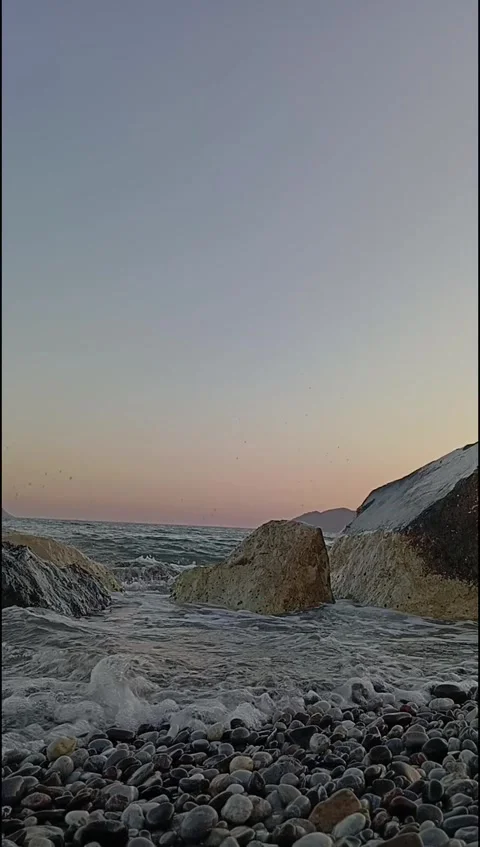 Ocean Wave Splash Between Coastal Rocks at Sunset – Tranquil Seascape Stock Footage 338185359