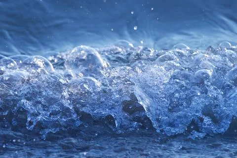 Ocean wave splashing on the beach. Stock Photos
