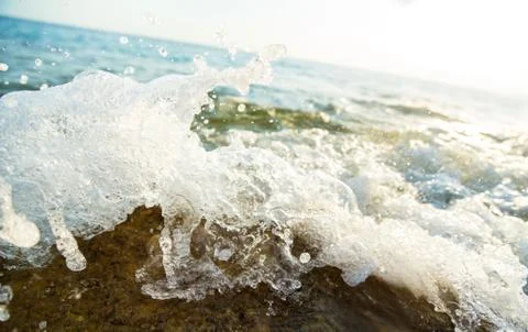 Ocean wave at sunset Stock Photos