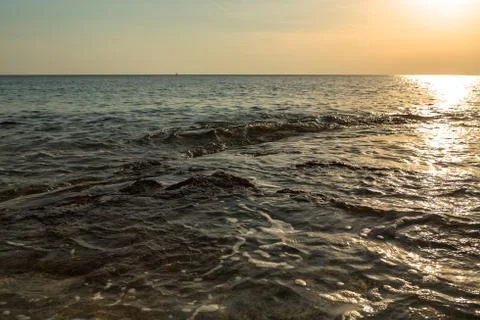 Ocean wave at sunset Stock Photos