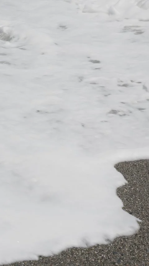 Ocean wave washing over dark sand beach Stock Footage 337901124