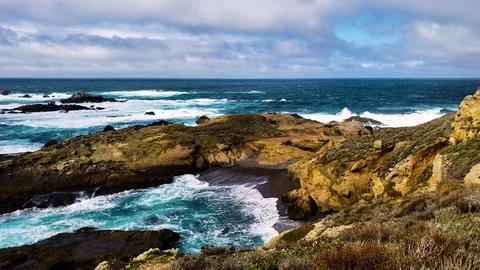 Ocean waves against cliffs on a cloudy California day. Video stock 107232204