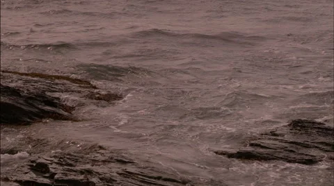 Ocean waves against rocks Stock Footage 53335904