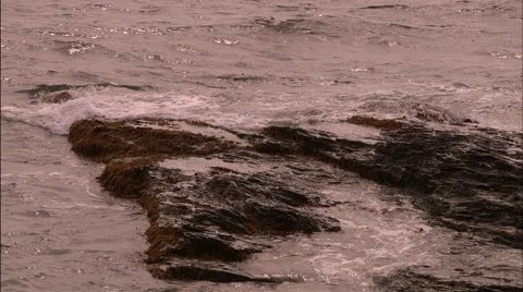 Ocean waves against rocks Stock Footage 53338216