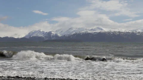 Ocean waves on an Alaskan beach with mountains. Stock Footage 24125100