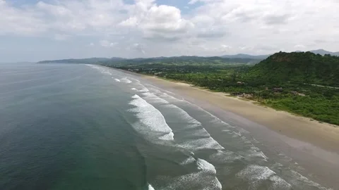 Ocean, waves and the beach in a cloudy day Stock Footage 145154210