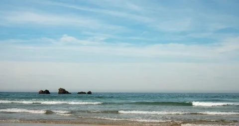 Ocean waves and distant rocks, wide seascape Stock Footage 318591937
