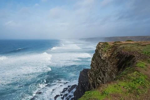 Ocean with waves and green cliffs landscape Stock Photos