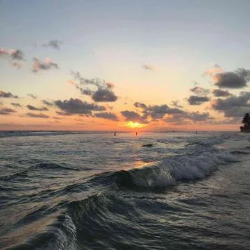 Ocean waves and sun set Stock Photos