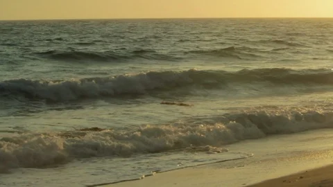 Ocean waves and sunset. Beach front view of sun hitting water. pan B Stock Footage 102403577