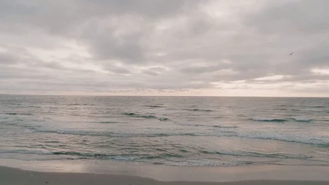 Ocean Waves on Beach Aerial on Cloudy Dark Sunrise Stock Footage 94424808