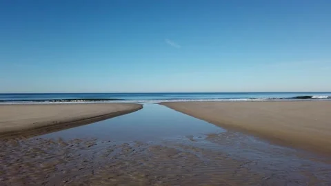 Ocean waves on the beach with a blue sky Stock Footage 239522487