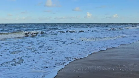 Ocean waves on the beach in continuous motion Stock Footage 326563656