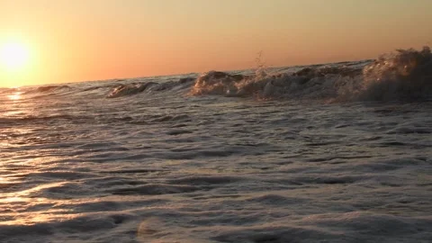 Ocean waves on the beach at sunset golden hour Stock Footage 327085095