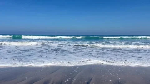 Ocean waves at the beach under a blue sky. Stock Footage 340127207