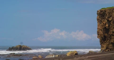 Ocean waves beating against the rocks on the tropical beach. Red camera. Stock Footage 86967903