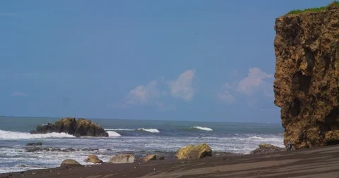 Ocean waves beating against the rocks on the tropical beach. Red camera. Stock Footage 86999115