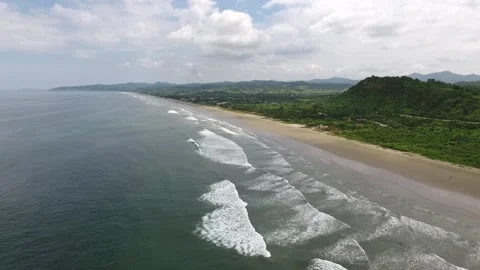 Ocean waves with beautiful small green mountain Stock Footage 145154289