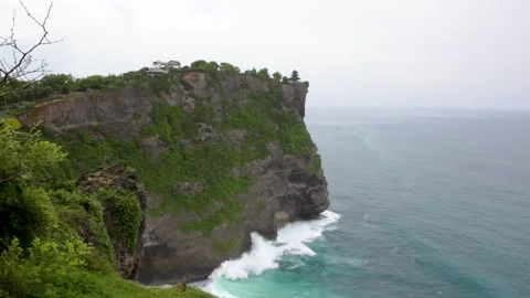 Ocean waves break against high coastal cliffs Stock Footage 149502415