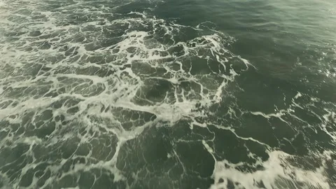 Ocean waves break against rugged cliffs Stock Footage 339790609