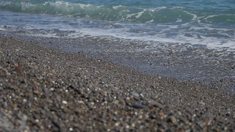 Ocean waves break on a pebble beach Stock Footage 98262423