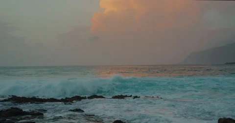 Ocean waves break on rocky beach with white sea foam. Close-up salty water in Stock Footage 237401424