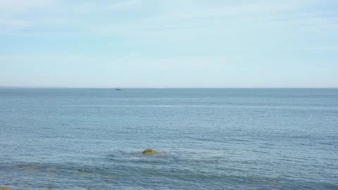 Ocean Waves Breaking Against a Rock Stock Footage 337119818