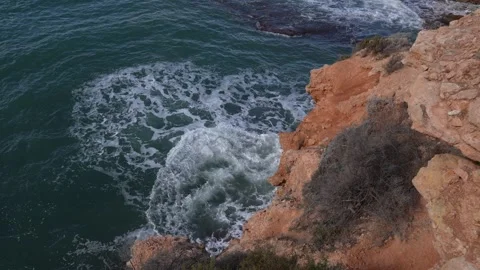 Ocean Waves Breaking Against Rocky Orange Cliffs 스톡 동영상 346926177