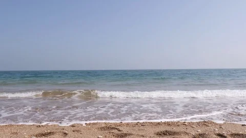 Ocean waves breaking against the sand 스톡 동영상 74603875