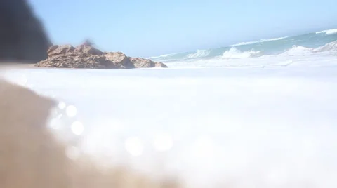Ocean waves breaking against the shore on a clear blue summer day Vídeos de archivo 32936192