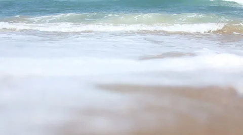 Ocean waves breaking against the shore on a clear blue summer day 動画素材 32936196