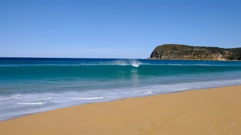 Ocean waves breaking and running up the beach on perfect blue sky day. Stock Footage 93724140